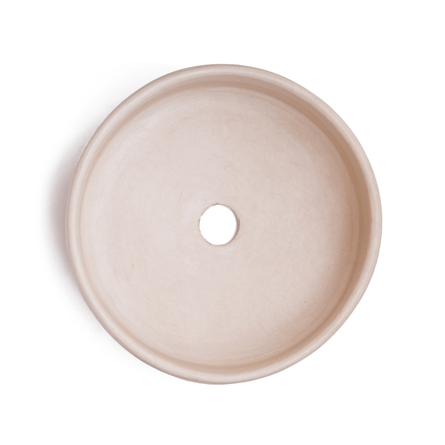 Top-down view of vessel sink interior displaying smooth cream-colored ceramic surface