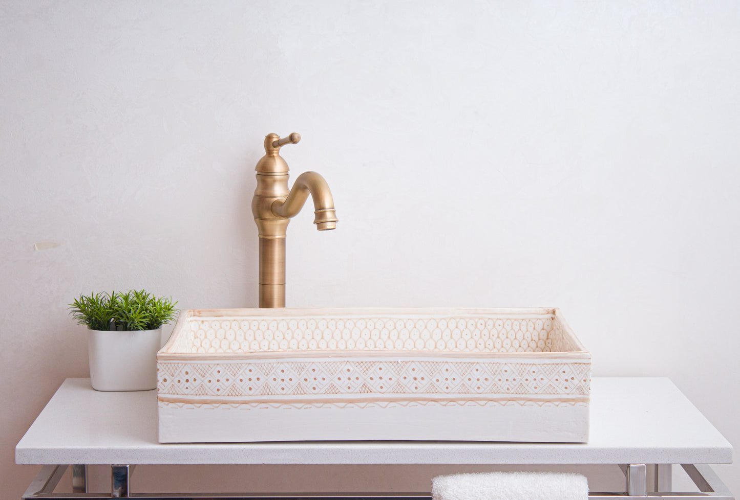 Front lifestyle view of beige vessel sink with brass faucet in contemporary bathroom setting