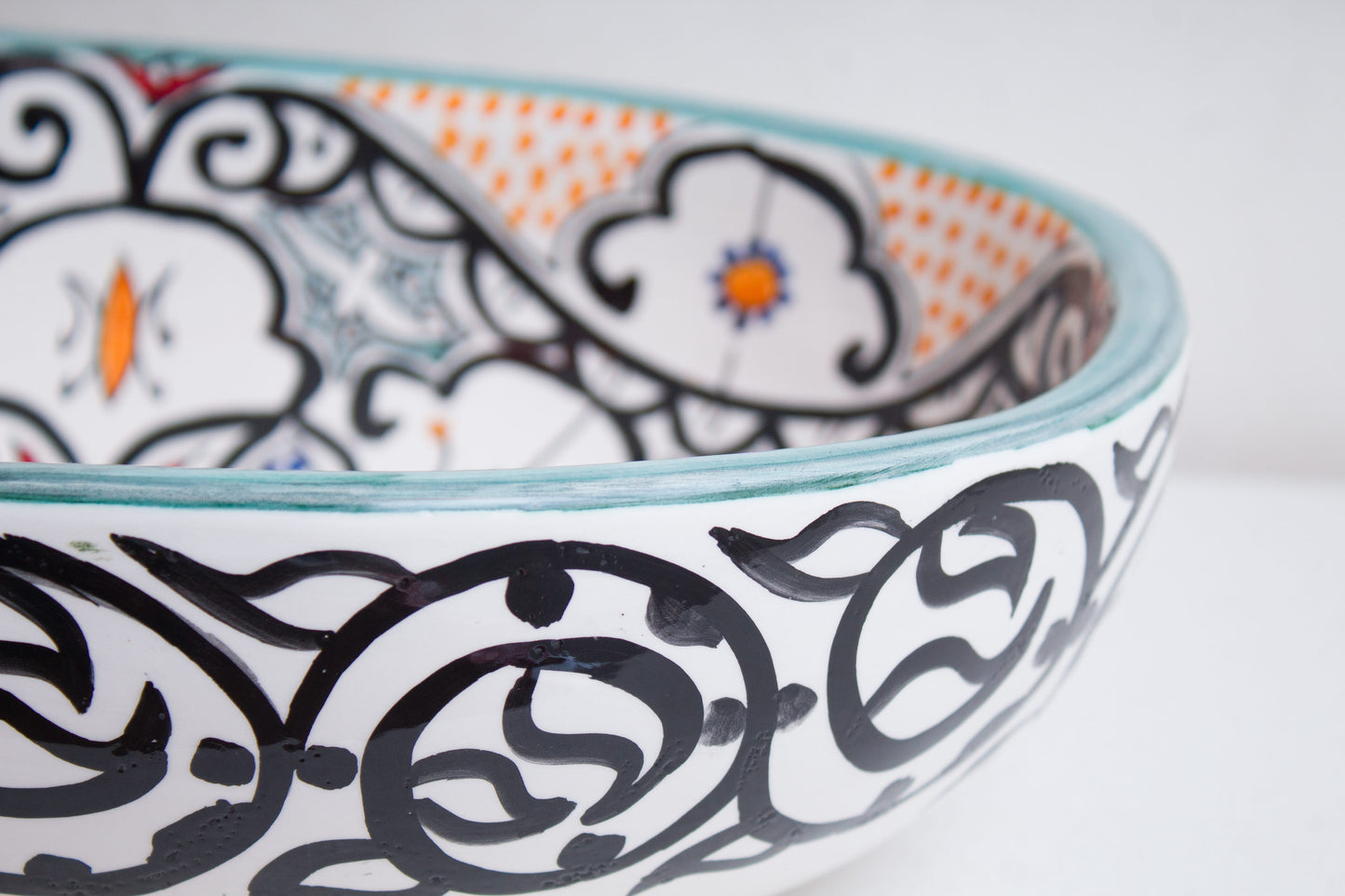 Close-up detail of intricate interlocking circular patterns on ceramic basin exterior
