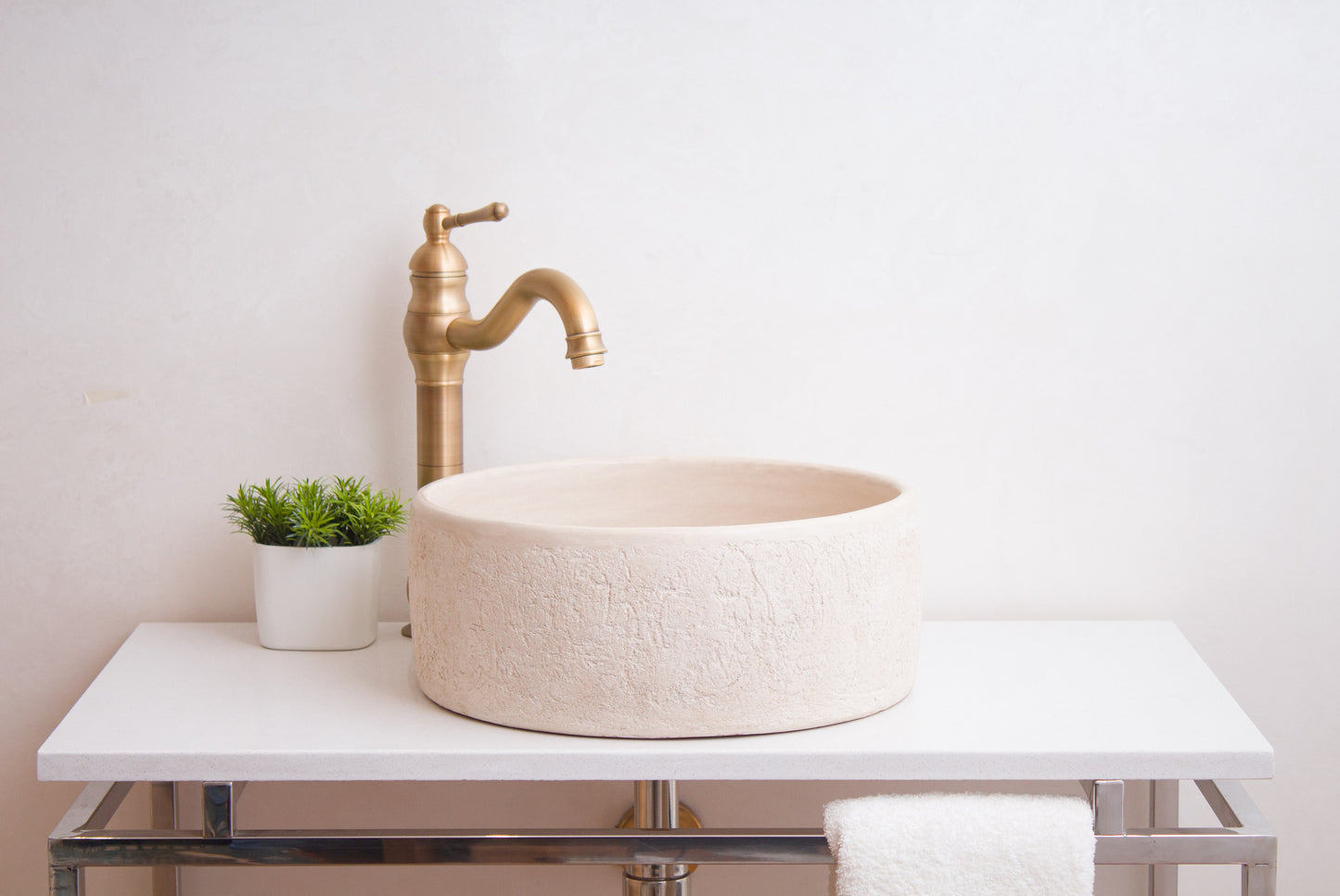 Front lifestyle view of textured ceramic basin positioned on contemporary vanity unit