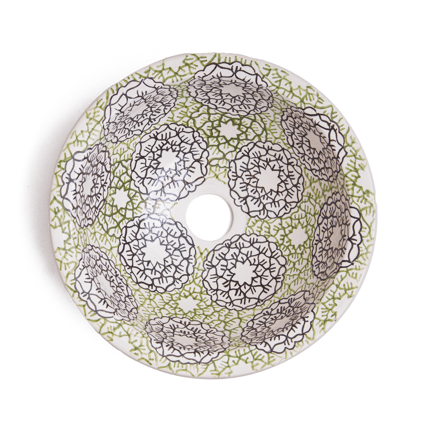Interior view of handcrafted ceramic basin displaying intricate green and brown geometric mandala patterns