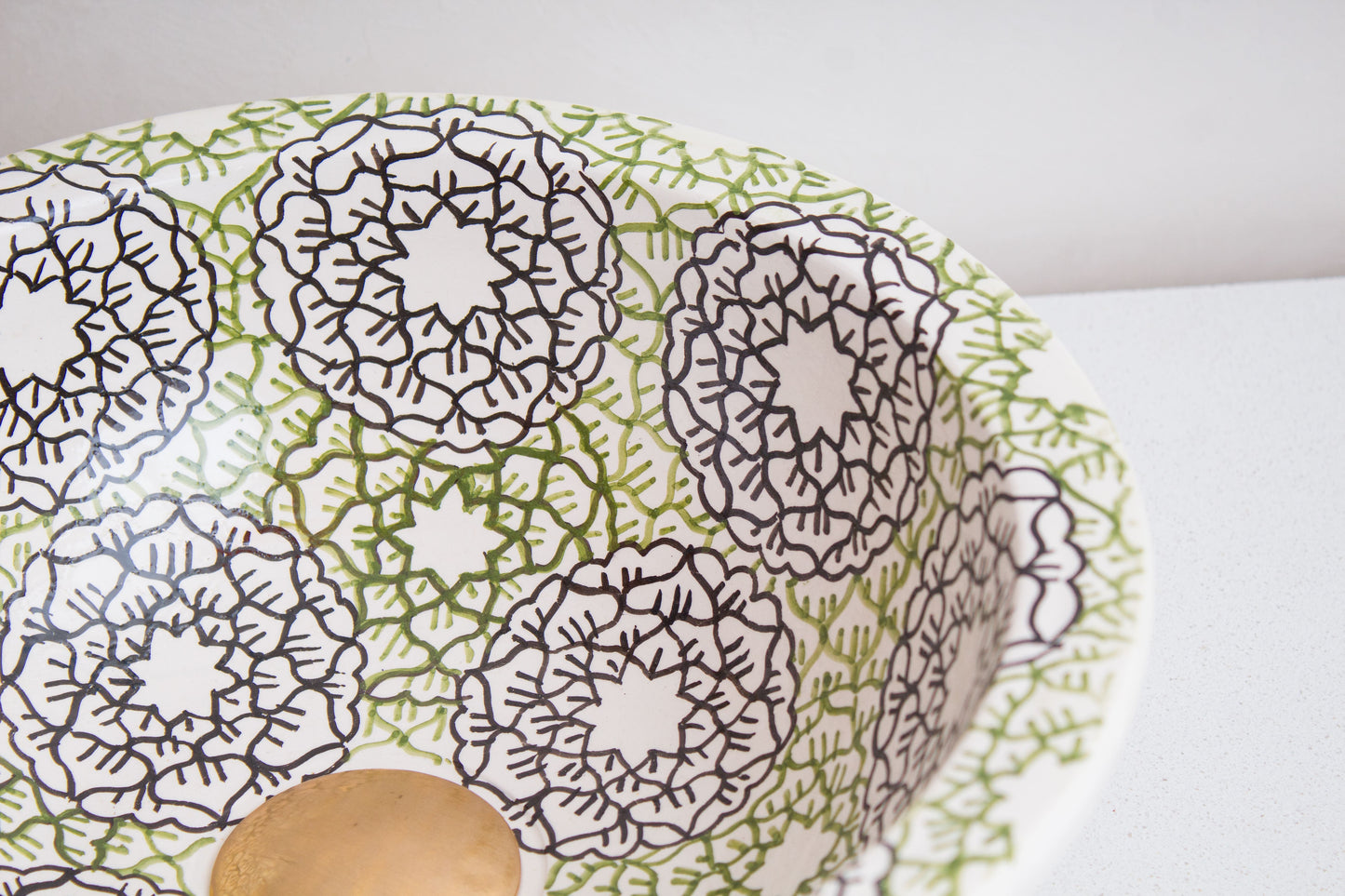 Detailed view of interior geometric designs showing star and floral motifs in green and brown colors