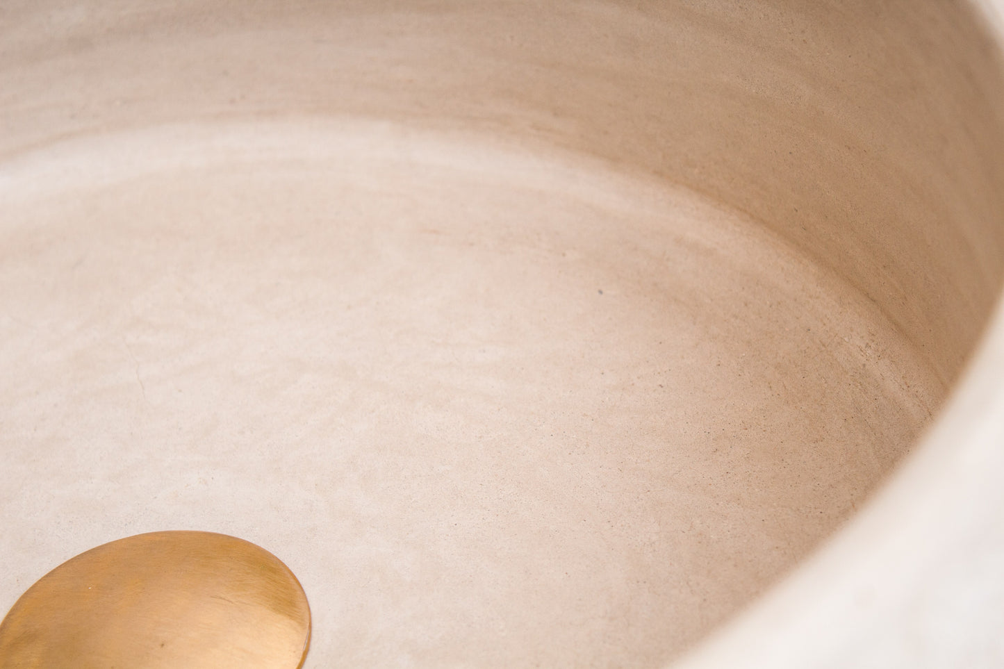 Detailed view of smooth interior surface contrasting with textured exterior walls