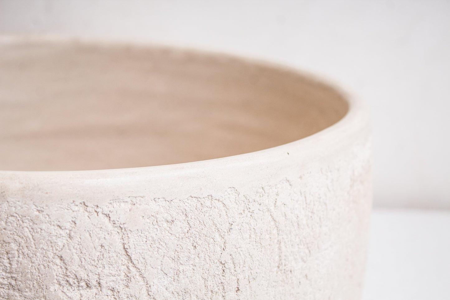 Close-up detail of organic textured rim showing handcrafted ceramic surface finish