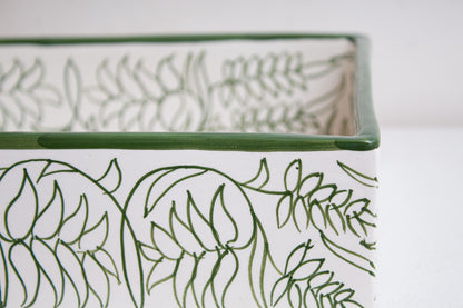 Close-up detail of green hand-drawn botanical motifs and decorative rim on artisan-crafted Moroccan ceramic bathroom basin