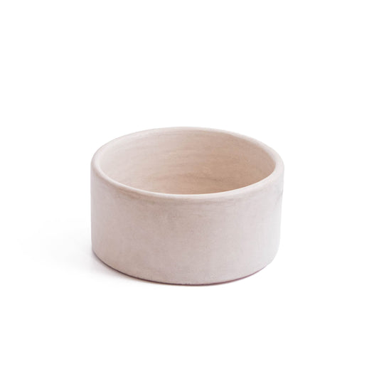 Side perspective view of round ceramic bathroom basin showcasing cylindrical shape and smooth beige tadelakt finish