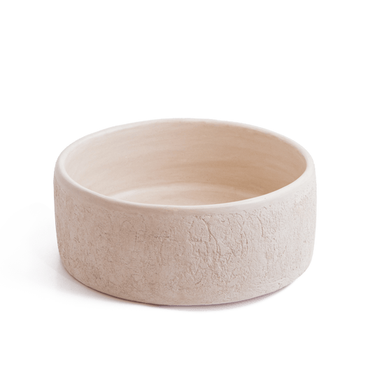 Angled perspective of round ceramic basin showcasing natural textured exterior finish