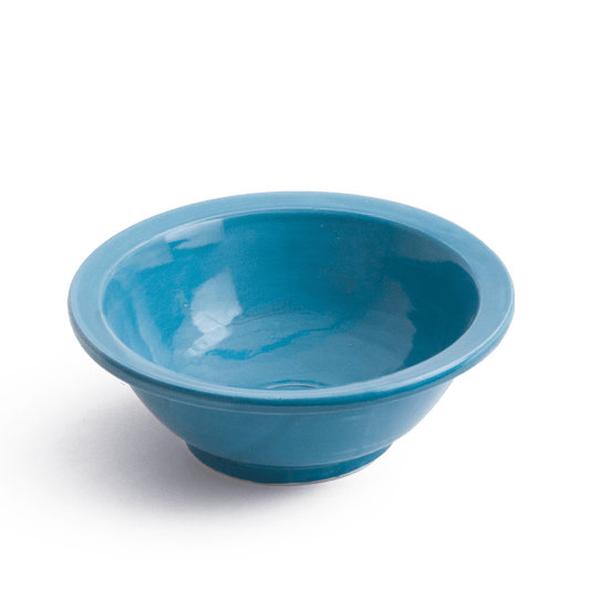 Three-quarter perspective view of blue ceramic vessel sink on white background showing the complete bowl shape and base