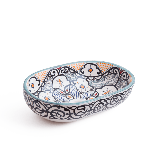 Angled perspective of oval ceramic basin showcasing three-dimensional form and pattern flow